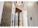 Entryway featuring black and gold patterned wallpaper and ornate doors and trim at 1409 N Park Ave, Indianapolis, IN 46202
