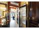 View through dark wood doors to a hallway with tile floor and a pool table at 1409 N Park Ave, Indianapolis, IN 46202