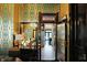 View through dark wood doors to a hallway with tile floor and a pool table at 1409 N Park Ave, Indianapolis, IN 46202