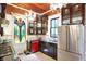 An updated kitchen features stainless steel appliances, a black countertop, and a colorful stained glass window at 1409 N Park Ave, Indianapolis, IN 46202