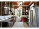 Kitchen with dark wood cabinets, mosaic tile floors, stainless appliances and a stained glass window at 1409 N Park Ave, Indianapolis, IN 46202