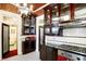 This kitchen features a black and white tile floor, white subway tile backsplash, and dark wood cabinets at 1409 N Park Ave, Indianapolis, IN 46202