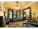 Elegant living room showcasing period lighting, stained glass windows and original floors at 1409 N Park Ave, Indianapolis, IN 46202