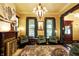 Living room featuring period lighting, gas fireplace, stained glass windows, and original floors at 1409 N Park Ave, Indianapolis, IN 46202