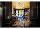 Dark wood doorway leads to a lounge area with chandelier, bar, and seating at 1409 N Park Ave, Indianapolis, IN 46202