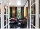 Living room is designed with dark wood floors, comfortable seating, and stylish decor, viewed through double doors at 1409 N Park Ave, Indianapolis, IN 46202