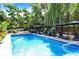 Sparkling blue pool surrounded by lounge chairs, umbrellas, and lush landscaping for ultimate relaxation and outdoor enjoyment at 1409 N Park Ave, Indianapolis, IN 46202
