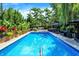 Inviting pool with landscaped surroundings, lounge chairs, and a backyard entertainment area at 1409 N Park Ave, Indianapolis, IN 46202
