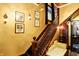 Elegant staircase with stained glass window and a vintage seating area with period lighting fixtures at 1409 N Park Ave, Indianapolis, IN 46202