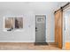 Bright entryway with a window, gray door, light walls, and a barn door at 150 W Jo Jo Ln, Nineveh, IN 46164