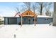 Charming single story home with covered porch, attached garage, and American flag in a snow covered yard at 150 W Jo Jo Ln, Nineveh, IN 46164