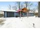 Charming single story home with covered porch, attached garage, and American flag in a snow covered yard at 150 W Jo Jo Ln, Nineveh, IN 46164