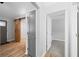 Bright hallway with luxury vinyl plank flooring and modern sliding barn door at 150 W Jo Jo Ln, Nineveh, IN 46164