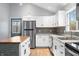 Bright kitchen with stainless steel refrigerator and white cabinets at 150 W Jo Jo Ln, Nineveh, IN 46164