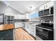 Modern kitchen features stainless steel appliances, gray backsplash and wood countertops at 150 W Jo Jo Ln, Nineveh, IN 46164