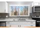 Bright kitchen featuring stainless steel appliances, gray backsplash, and double sink at 150 W Jo Jo Ln, Nineveh, IN 46164