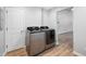 Modern laundry room featuring a gray washer and dryer, and wood-look vinyl plank flooring at 150 W Jo Jo Ln, Nineveh, IN 46164