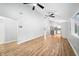 Sunlit open-plan living room with wooden floors, neutral walls, and ceiling fans at 150 W Jo Jo Ln, Nineveh, IN 46164