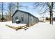 Backyard view of home with a wooden deck covered in snow at 150 W Jo Jo Ln, Nineveh, IN 46164
