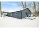 Backyard view of home with a wooden deck covered in snow at 150 W Jo Jo Ln, Nineveh, IN 46164