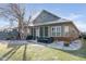 Inviting backyard with patio, outdoor seating, and manicured lawn in partial snow cover for outdoor enjoyment at 15179 Kampen Cir, Carmel, IN 46033
