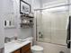Well-lit bathroom featuring a shower/tub combo, wood vanity, and modern shelving at 15179 Kampen Cir, Carmel, IN 46033