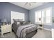 Cozy bedroom with neutral tones, a comfortable bed, and window with shutter-style blinds at 15179 Kampen Cir, Carmel, IN 46033