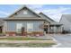 Charming single-Gathering home with blue siding, brick accents, and well-maintained landscaping at 15179 Kampen Cir, Carmel, IN 46033