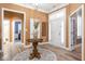 Welcoming foyer with hardwood floors, wainscoting, and ample natural light at 15179 Kampen Cir, Carmel, IN 46033
