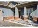 Inviting covered front porch with seating, brick accents, and decorative columns at 15179 Kampen Cir, Carmel, IN 46033