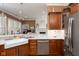 Open-concept kitchen with modern appliances, bright countertops, and stainless steel dishwasher at 15179 Kampen Cir, Carmel, IN 46033