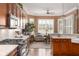 Modern kitchen showcasing granite countertops, gas range, stainless appliances and comfortable seating at 15179 Kampen Cir, Carmel, IN 46033