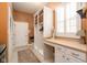 Well-organized laundry room with built-in storage, counter space, and a convenient window for natural light at 15179 Kampen Cir, Carmel, IN 46033