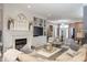 Bright living room with a fireplace, built-in shelving, and comfortable seating arrangement at 15179 Kampen Cir, Carmel, IN 46033