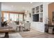 Open-concept living room featuring built-in shelving, and lots of natural light at 15179 Kampen Cir, Carmel, IN 46033