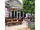 A spacious outdoor patio features seating and a table setting with a striped umbrella, perfect for entertaining guests at 15179 Kampen Cir, Carmel, IN 46033