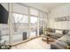 Inviting sunroom featuring glass doors to the patio, comfortable seating, and views of the backyard at 15179 Kampen Cir, Carmel, IN 46033