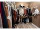Spacious walk-in closet features ample storage with shelves and rods for organized clothing and accessories at 15179 Kampen Cir, Carmel, IN 46033