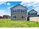 Back exterior of a modern home with a well-manicured lawn and ample space for outdoor enjoyment at 1624 Prospect St, Indianapolis, IN 46203