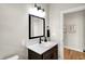 Modern bathroom with a dark vanity, sleek mirror, and minimalist decor at 1624 Prospect St, Indianapolis, IN 46203