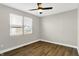 Bright bedroom features hardwood floors, a ceiling fan, and a large window at 1624 Prospect St, Indianapolis, IN 46203