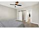 Bedroom with sliding door leading to bathroom, featuring a ceiling fan, and stylish decor at 1624 Prospect St, Indianapolis, IN 46203