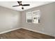 Bedroom featuring wood floors, ceiling fan and a large window at 1624 Prospect St, Indianapolis, IN 46203