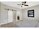 Bedroom featuring a ceiling fan, a window with natural light, and stylish decor at 1624 Prospect St, Indianapolis, IN 46203