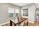 Bright dining area with a wooden table, modern chairs, and large windows, complemented by stylish decor at 1624 Prospect St, Indianapolis, IN 46203