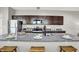 Kitchen showcasing a granite countertop island with seating, complemented by stainless steel appliances and ample cabinet space at 1624 Prospect St, Indianapolis, IN 46203