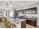 Modern kitchen with granite countertops, stainless steel appliances, dark cabinetry, and an island with bar seating at 1624 Prospect St, Indianapolis, IN 46203