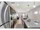 Modern kitchen features stainless steel appliances, a granite countertop island with seating, and an open layout to the living area at 1624 Prospect St, Indianapolis, IN 46203