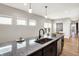 Kitchen with a granite countertop island and seating, showcasing stainless steel appliances and modern lighting at 1624 Prospect St, Indianapolis, IN 46203