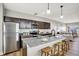 Bright kitchen with stainless steel appliances, granite countertops, dark wood cabinets, and a central island with seating at 1624 Prospect St, Indianapolis, IN 46203